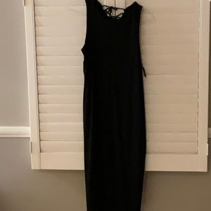 Formfitting black stretch dress with lace up back